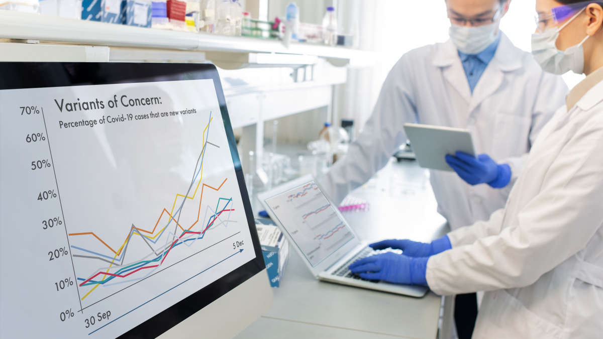 Two scientists in a laboratory working on computer screens